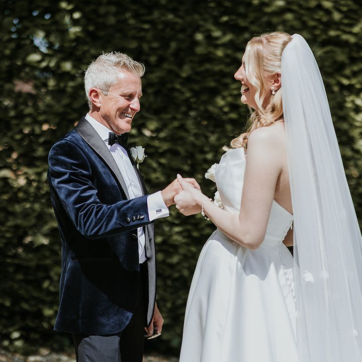 father-of-the-bride-in-blue-velvet-jacket-greeting-bride