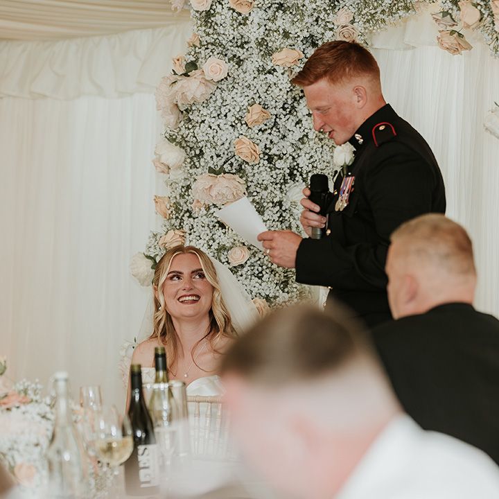 groom-reads-out-his-wedding-speech-at-marquee-reception