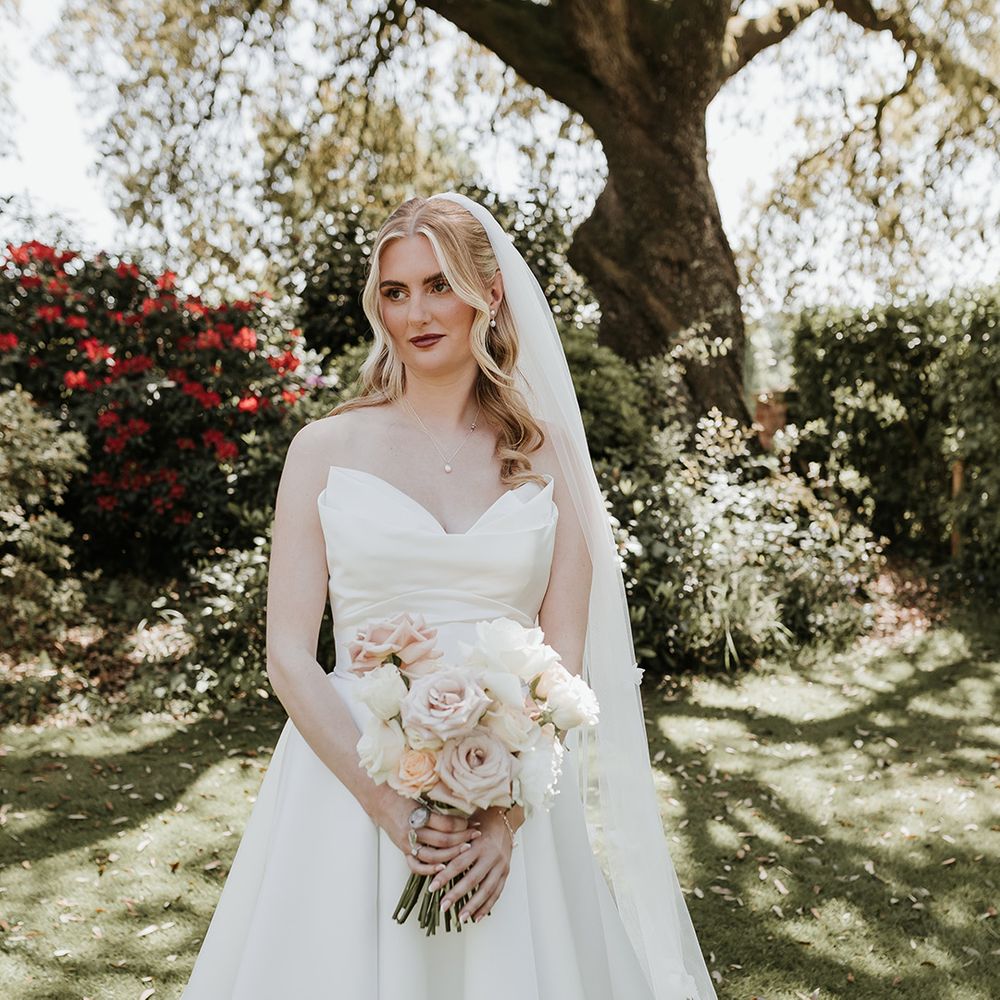 strapless-sweetheart-wedding-dress-carrying-pink-and-white-wedding-bouquet