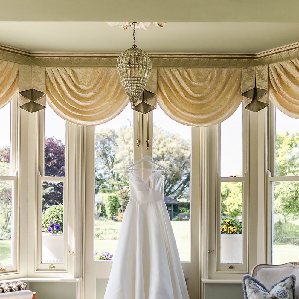 strapless-wedding-dress-on-hanger-in-bay-windows