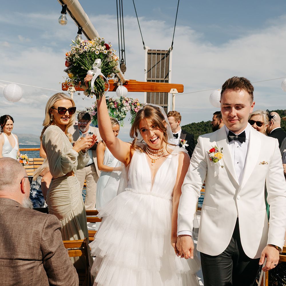 Unique boat wedding as couple walks back down the aisle as a married couple