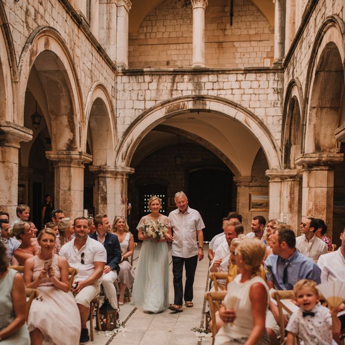 Father of the bride walks bride down the aisle at Croatia wedding