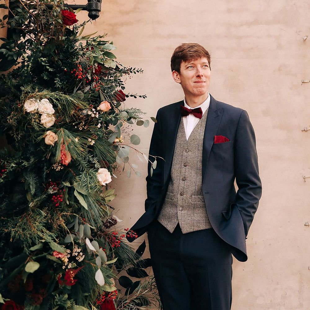 Navy winter wedding suit with grey waistcoat and red bowtie