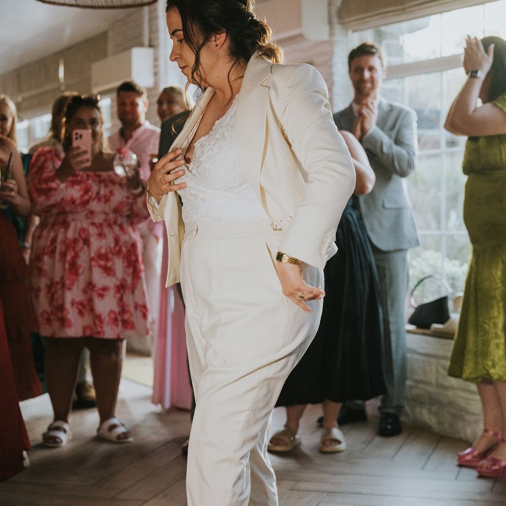 bride-dancing-in-bridal-suit-and-trainers