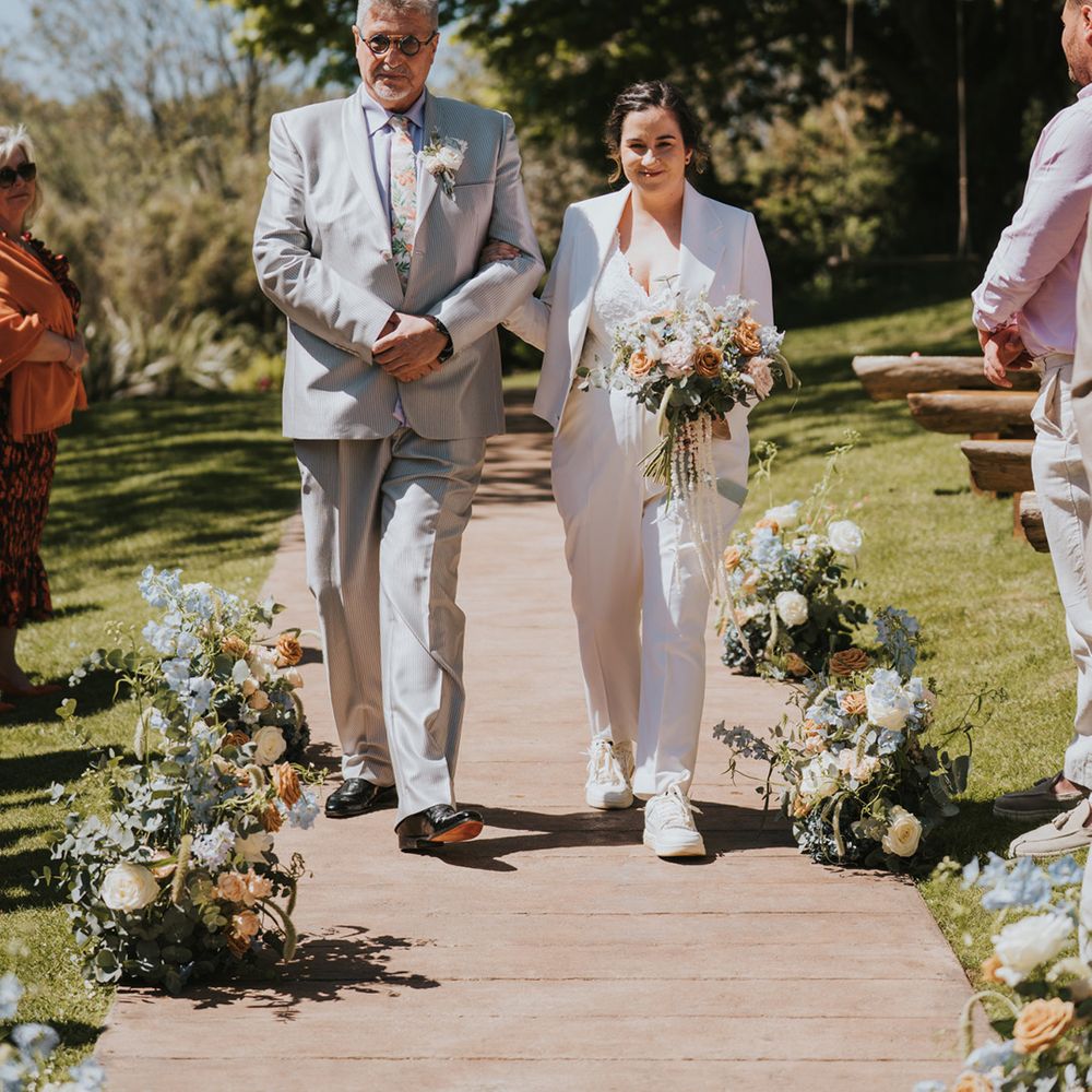 bride-in-suit-walks-down-the-aisle