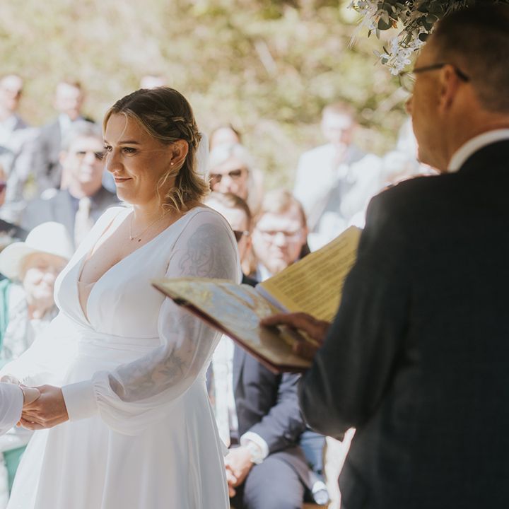 brides-exchanging-vows-at-outdoor-coastal-wedding