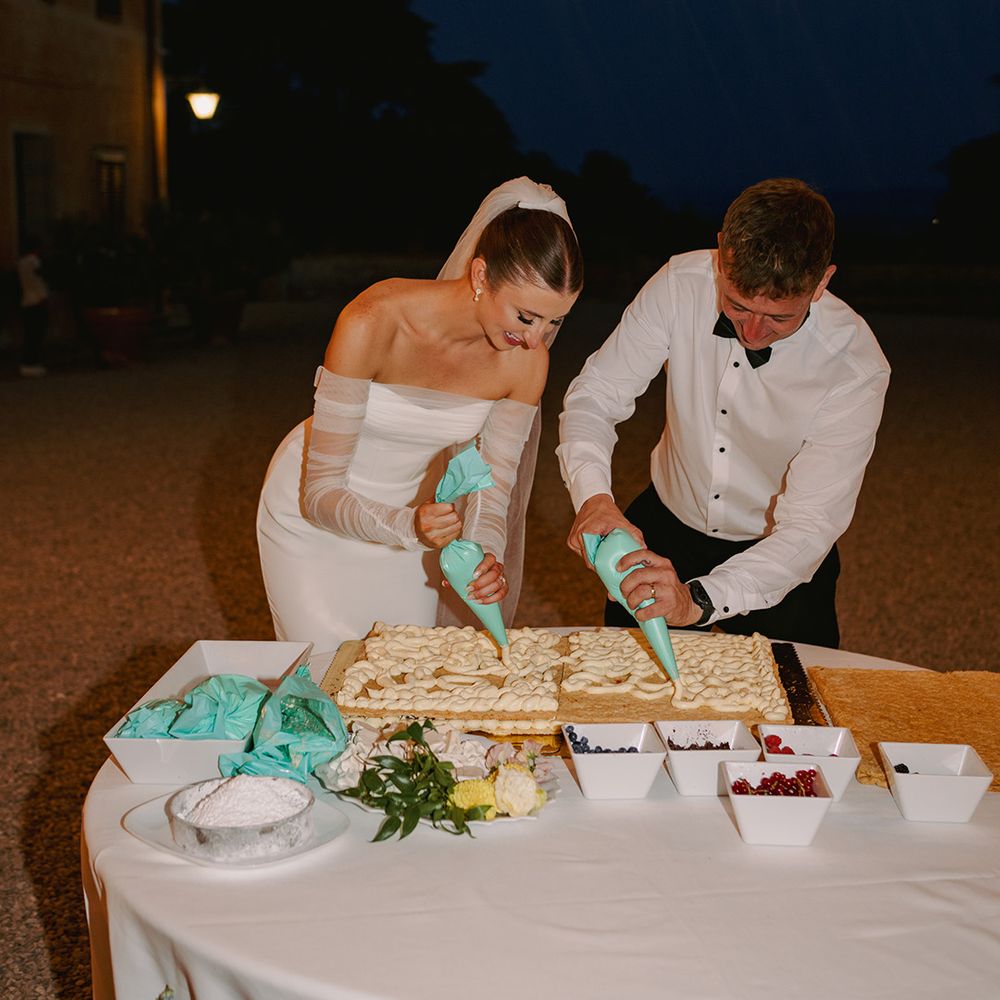 bride-and-groom-make-their-own-mille-foglie-wedding-cake