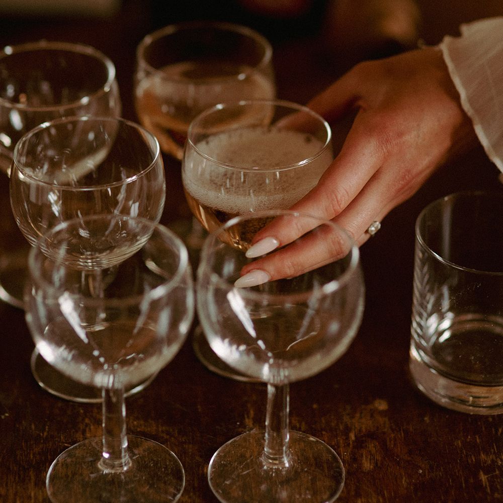 bride-reaches-for-champagne