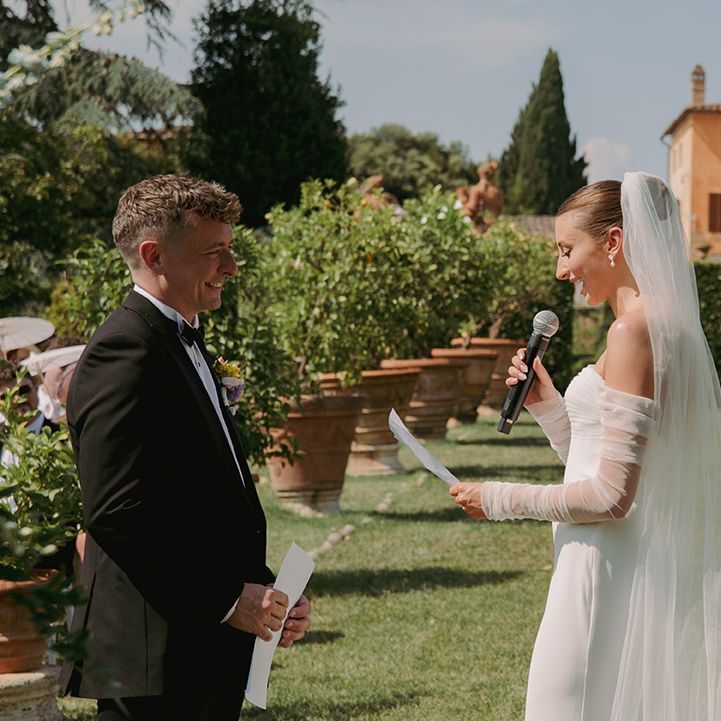 bride-reads-wedding-vows-at-outdoor-wedding-ceremony