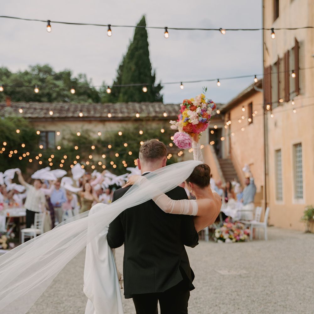 groom-carries-bride-into-the-wedding-entrance