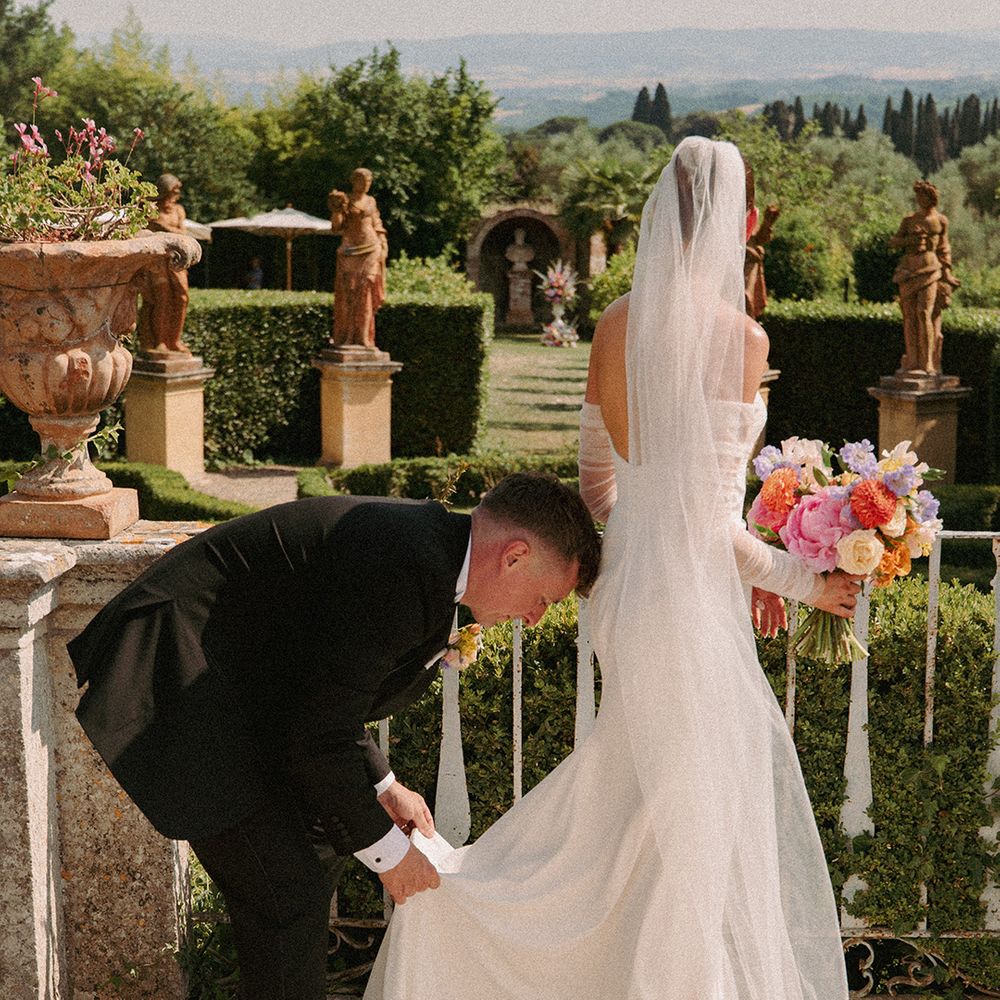 groom-helps-bride-with-shoes