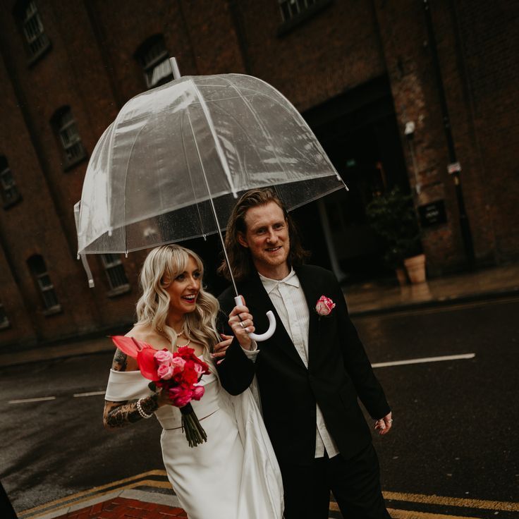 Bride & Groom Under Clear Umbrella On Rainy Wedding Day For City Wedding
