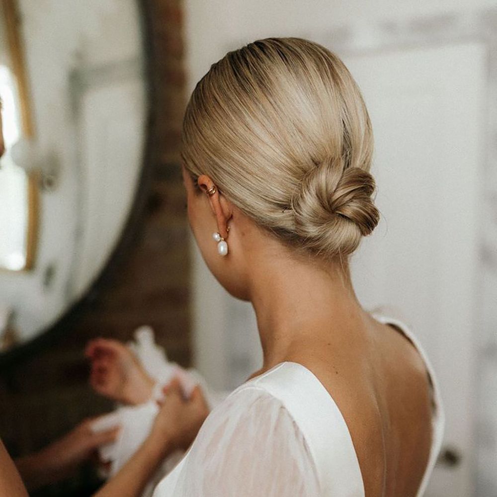 Bride with blonde hair in sleek updo with braided bun