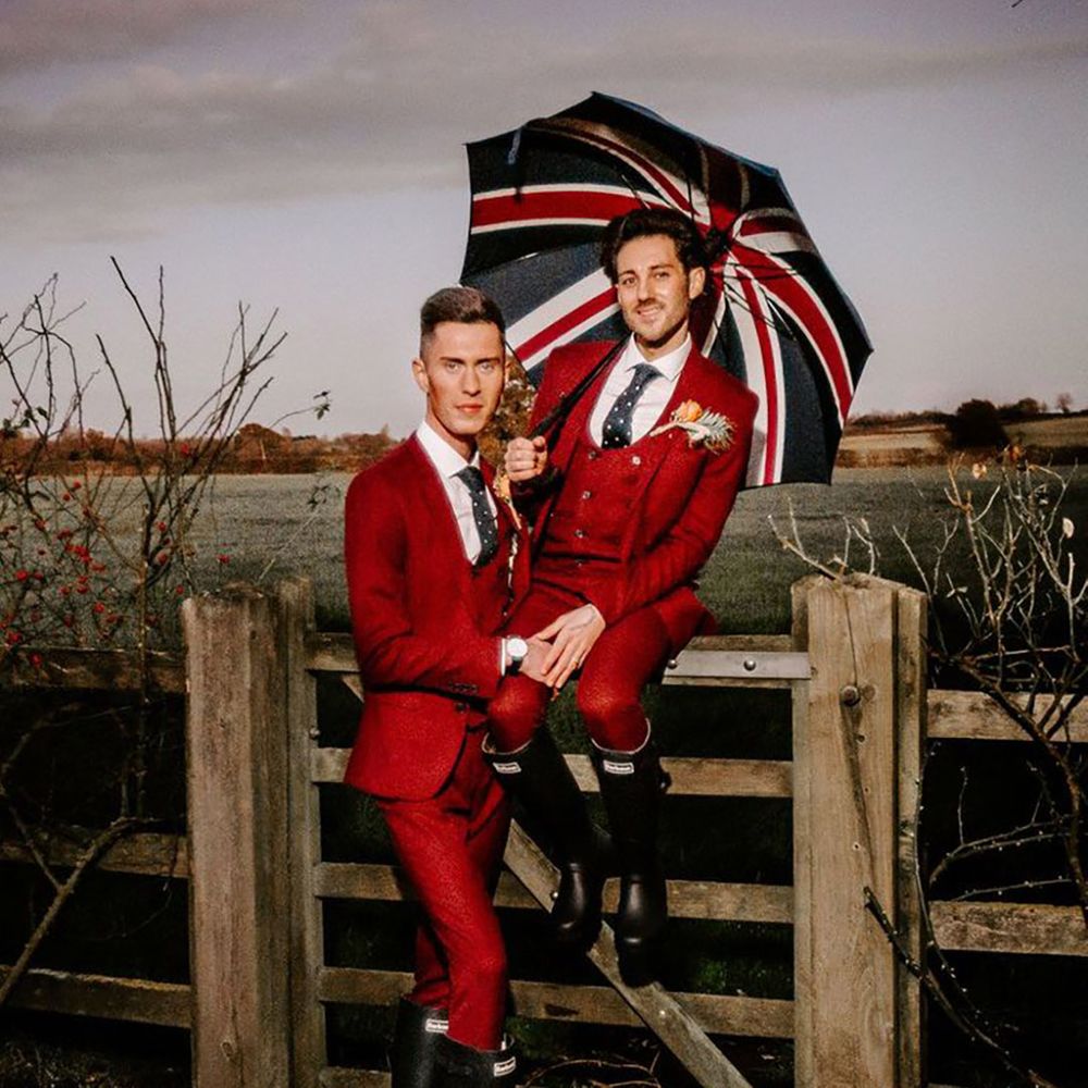 Two grooms with Union Jack umbrellas