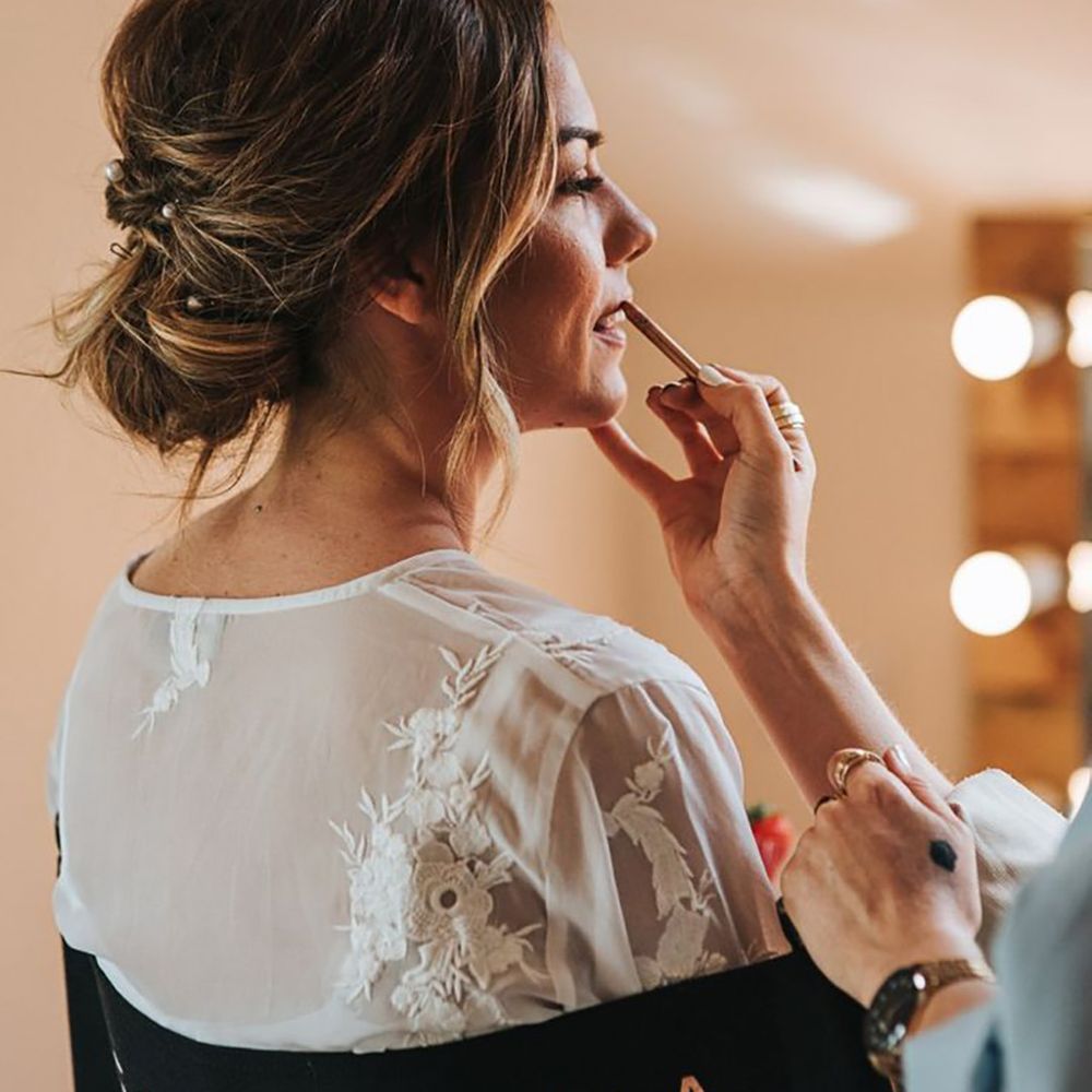 Bride gets her makeup done for her wedding day 