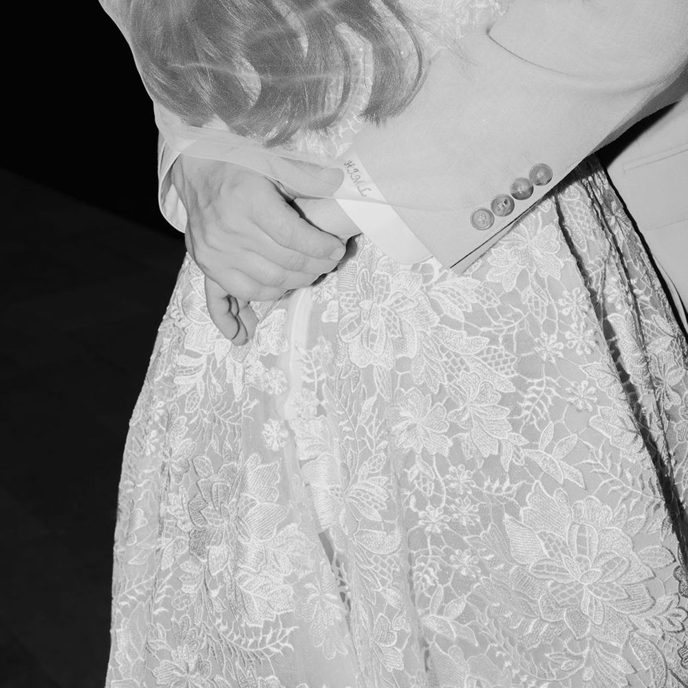 black-and-white-photo-as-groom-embraces-bride