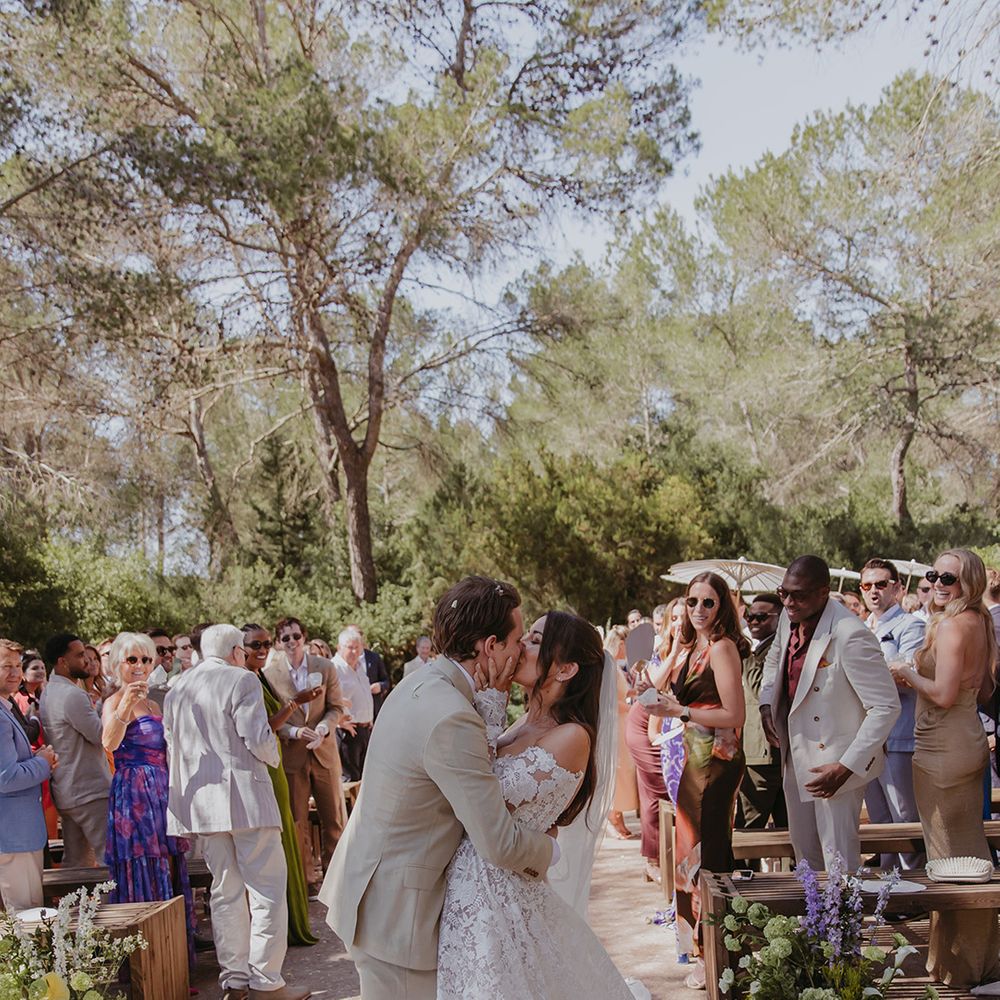 bride-and-groom-kiss-at-the-end-of-the-aisle
