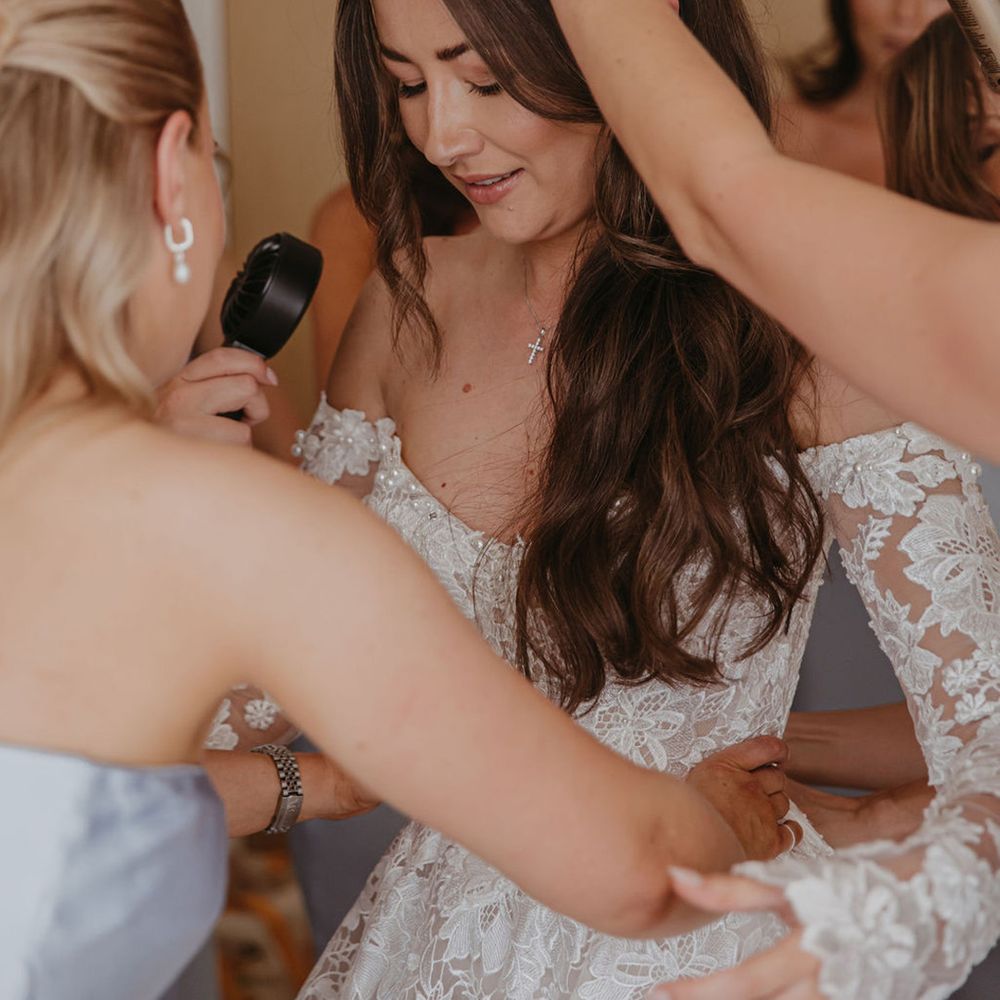 bridesmaids-help-bride-get-ready-for-wedding-day