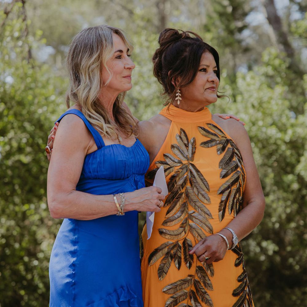 mother-of-the-bride-and-mother-of-the-groom-stand-together