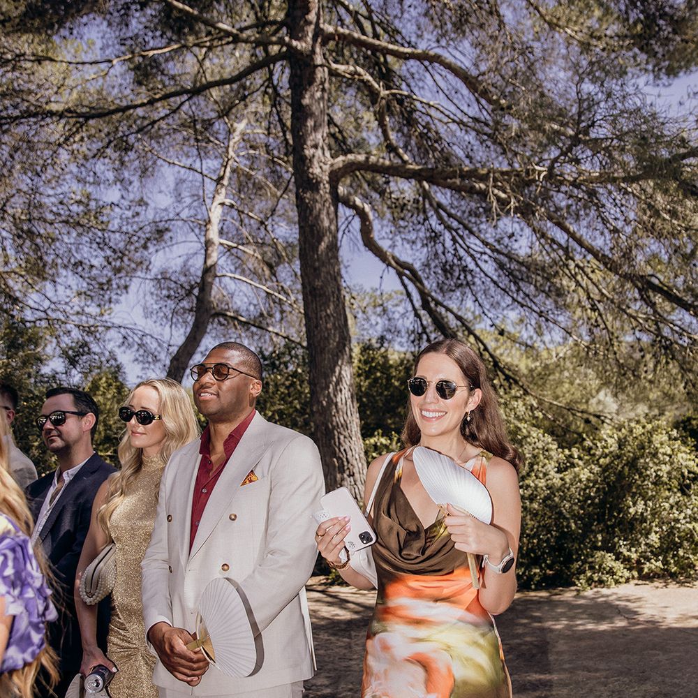 wedding-guest-in-floral-pattern-dress-standing-for-ceremony