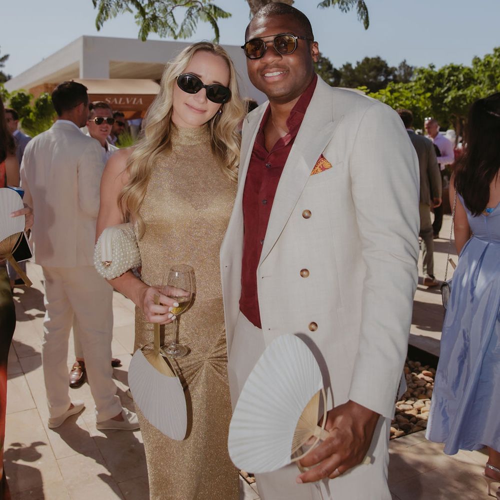 wedding-guests-posing-for-camera-in-white-suit-and-gold-dress