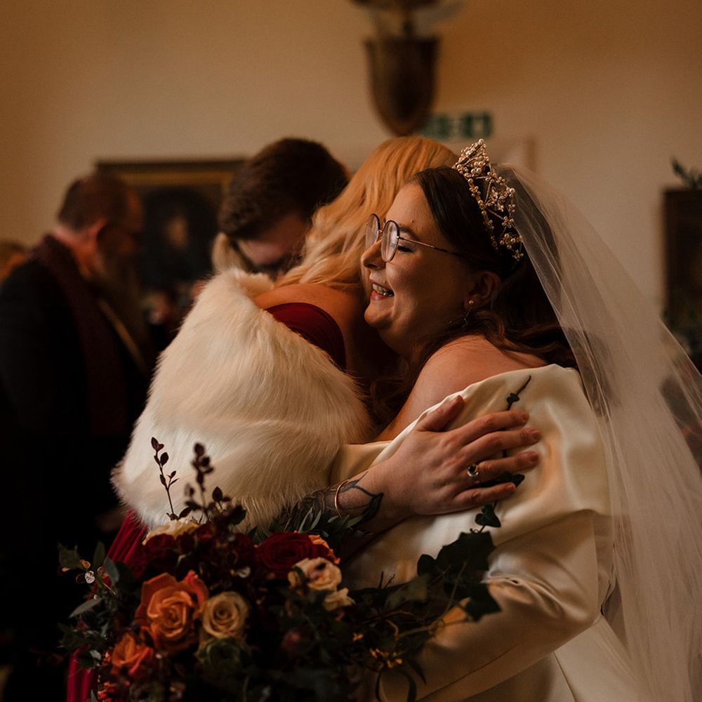 wedding-guests-hug-bride