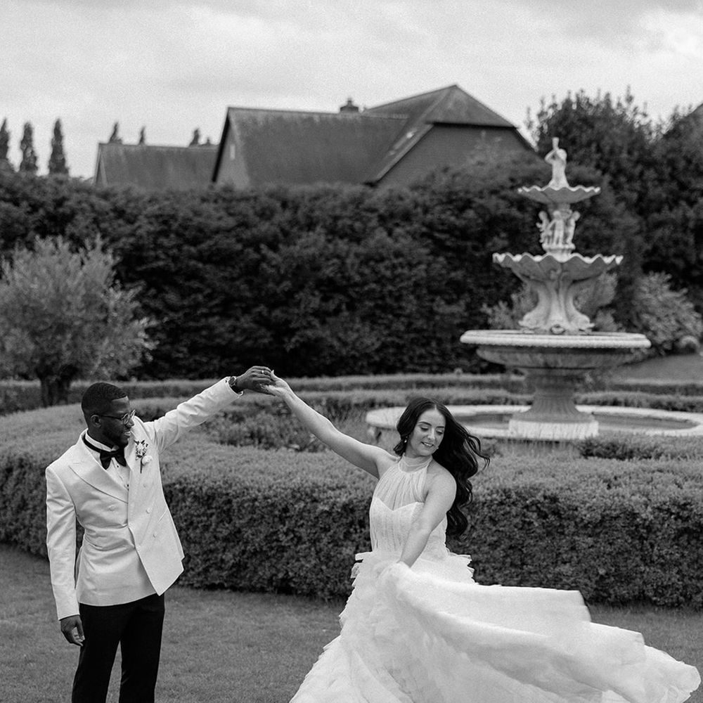 bride-and-groom-dancing-together-next-to-wedding-fountain