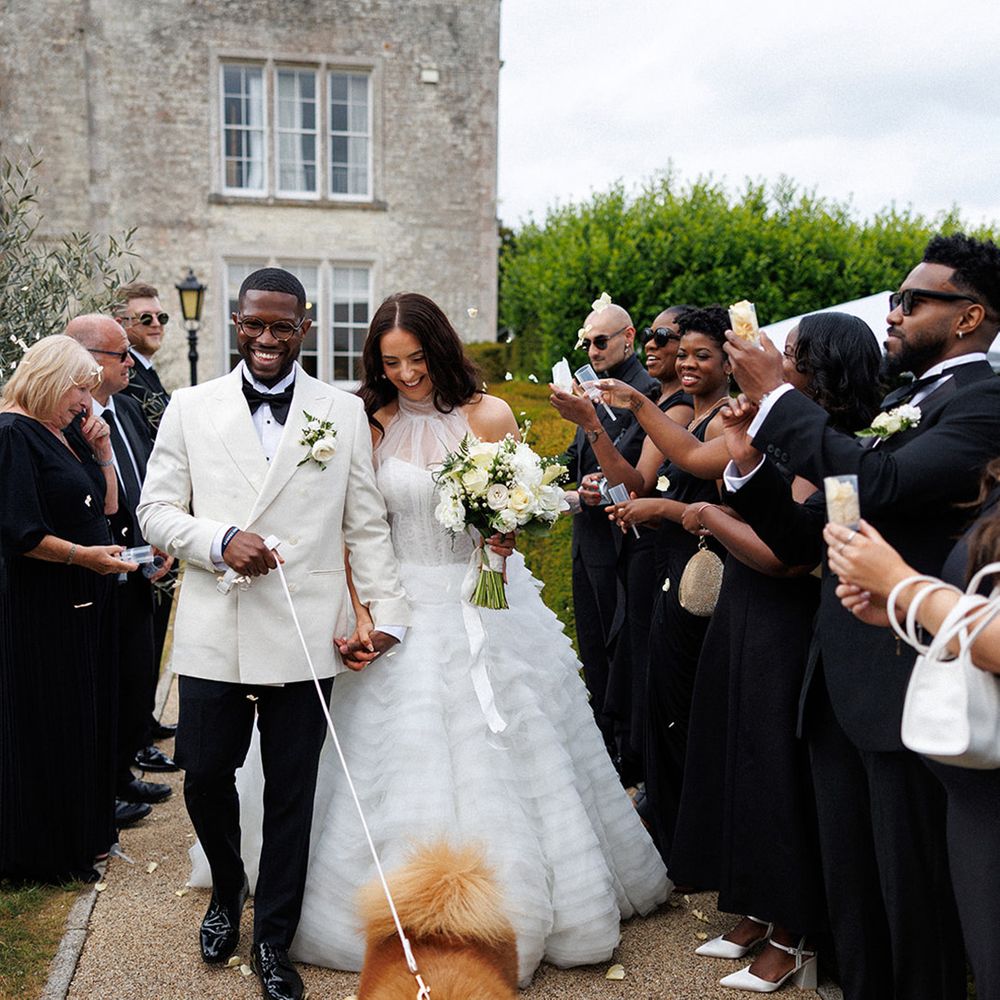 confetti-moment-as-couple-walks-with-their-pet-dogs