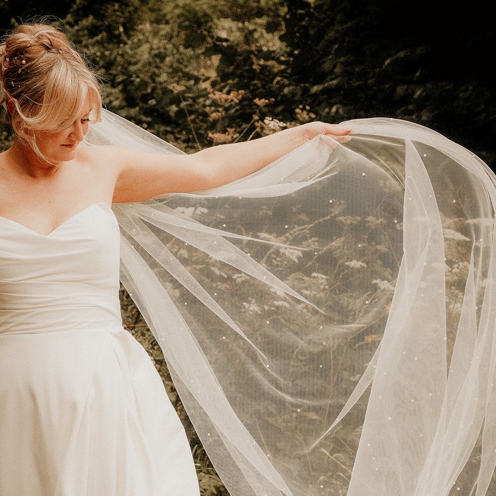 bride-in-strapless-wedding-dress-with-pearl-wedding-veil