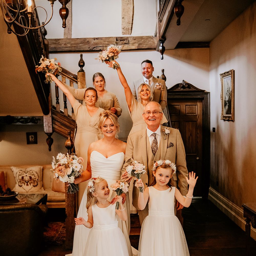 wedding-party-wearing-neutral-style-bridesmaid-dresses-and-suits