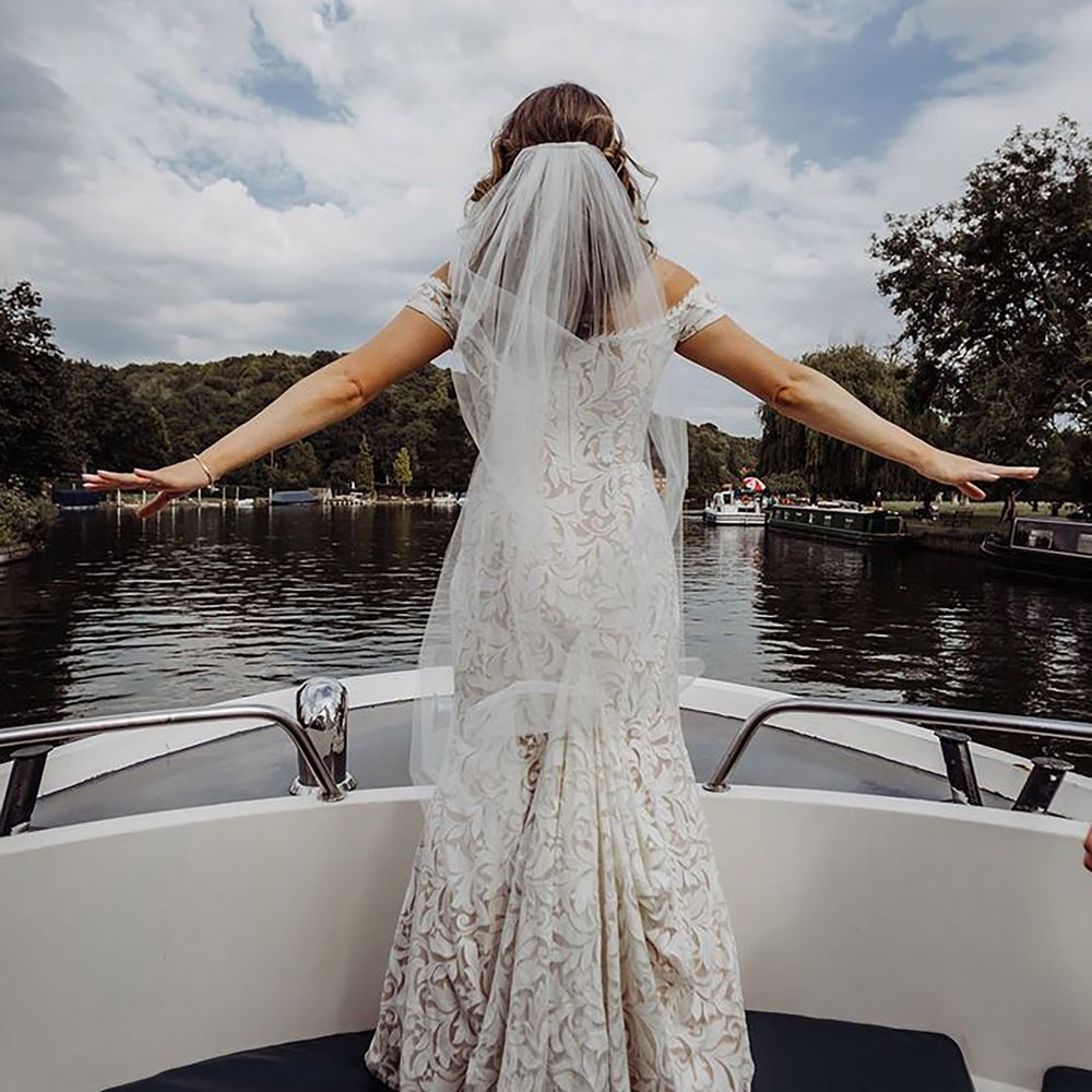 Bride doing the Titanic pose on a boat