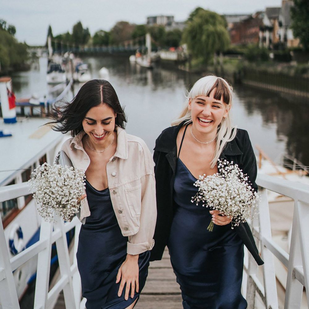 Bridesmaids in navy midi bridesmaid dresses for boat wedding