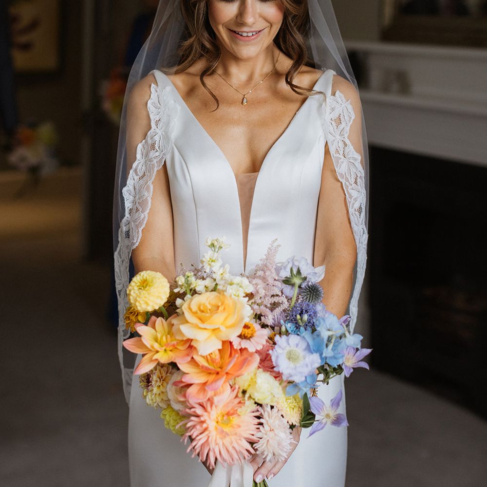 bride-in-plunge-wedding-dress-with-embroidered-lace-edge-wedding-veil