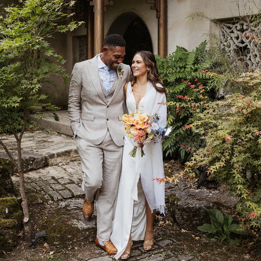 groom-walks-with-bride-for-couple-portraits