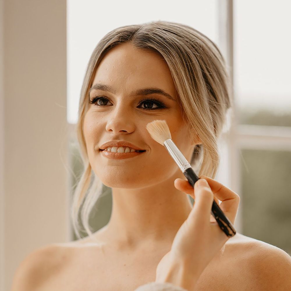 Classic bridal makeup by a professional makeup artist with smoky eyes and light pink lip