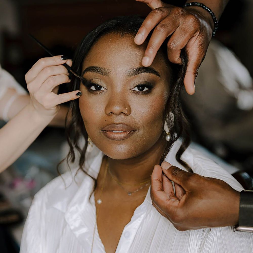 Bride getting makeup professionally done on wedding day
