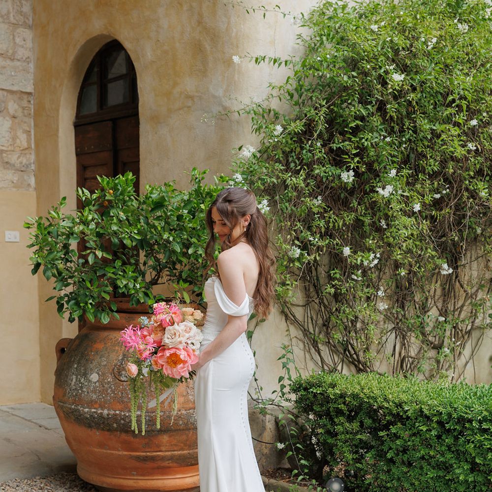 bride-in-off-the-shoulder-wedding-dress-with-pink-bouquet