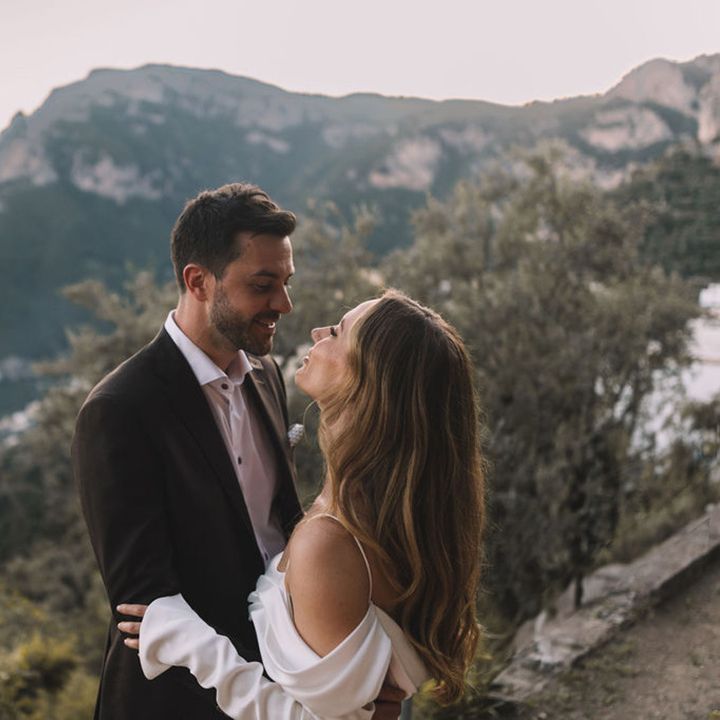 bride-and-groom-lean-in-for-a-kiss-at-positano-wedding