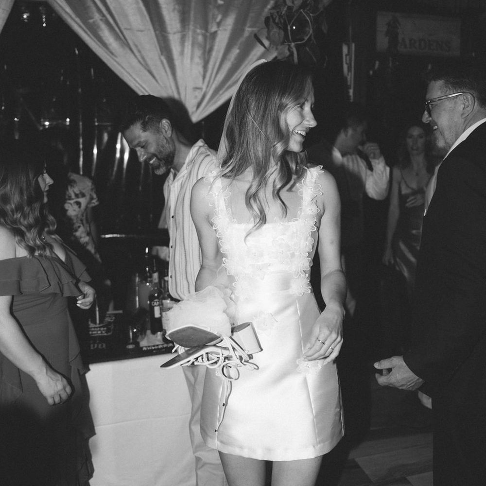 bride-wearing-short-wedding-dress-with-3d-floral-detailing