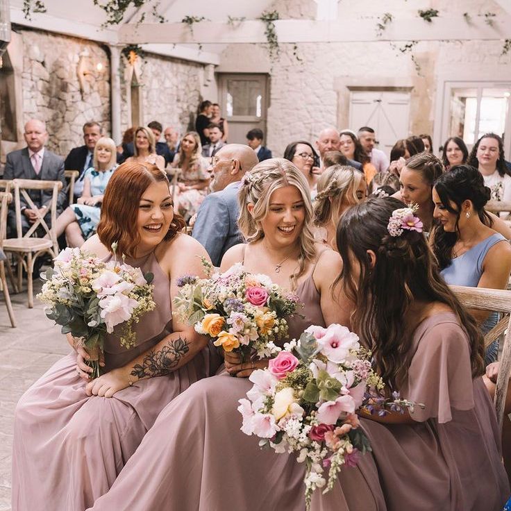 Bridesmaids in Purple Bridal Party Holding Bouquet of Colourful Spring Flowers
