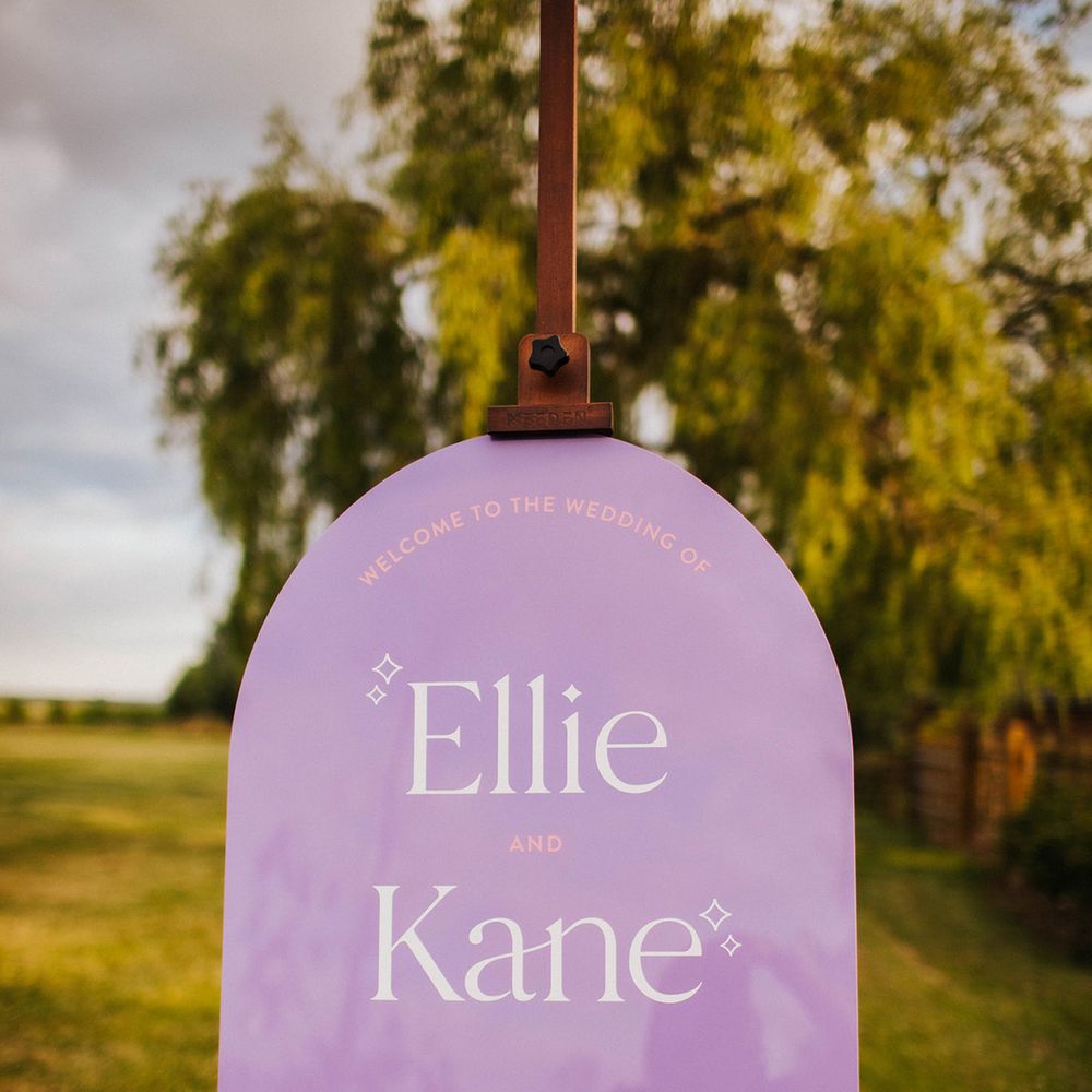 purple-arched-wedding-welcome-sign