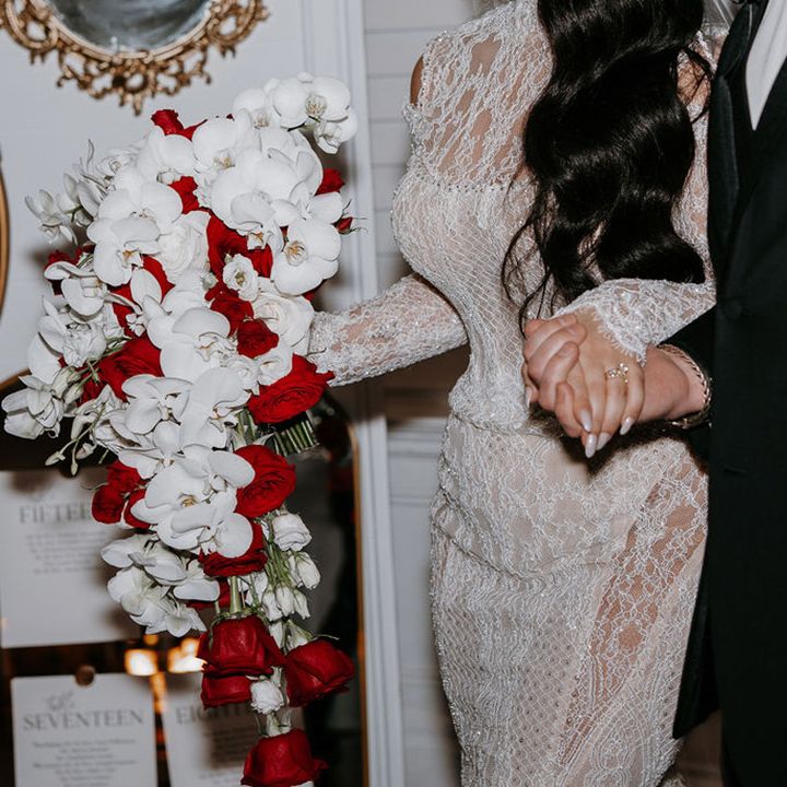 bride-and-groom-holding-hands-at-luxe-wedding