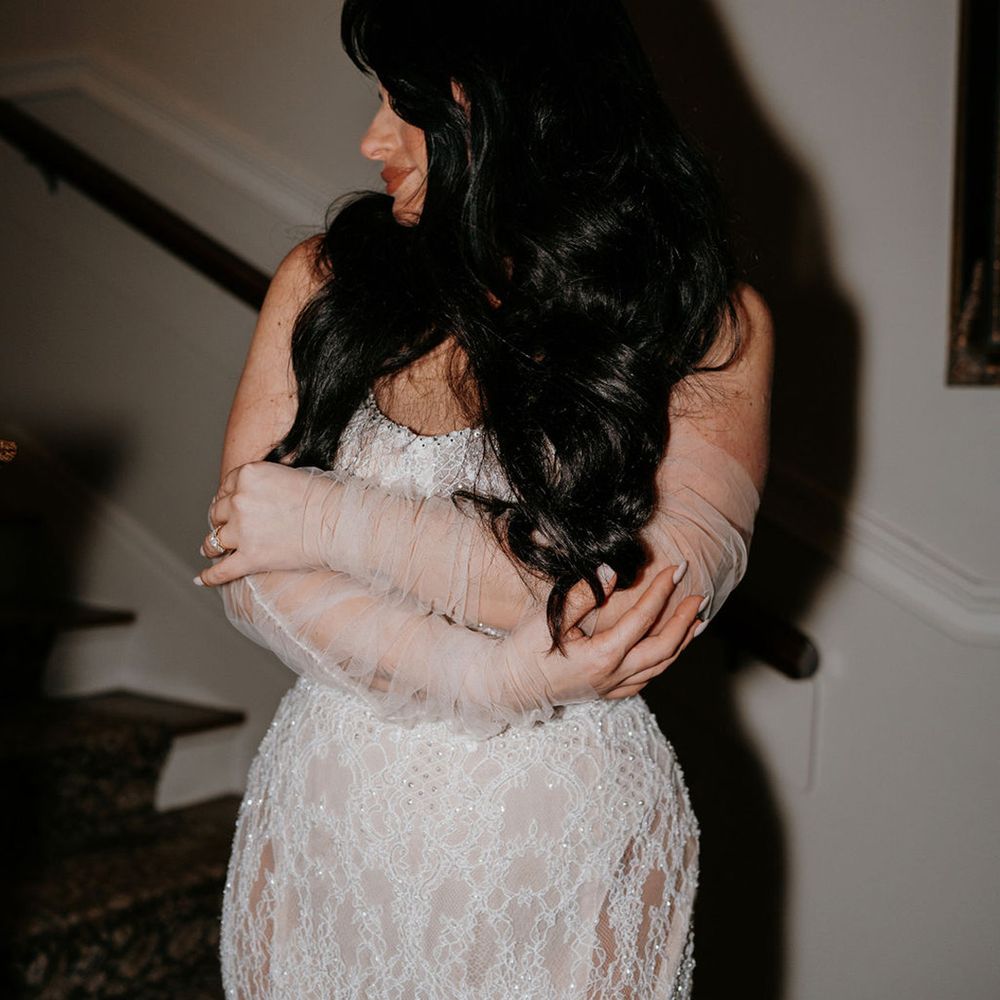 bride-with-long-dark-curly-hair-in-fitted-wedding-dress