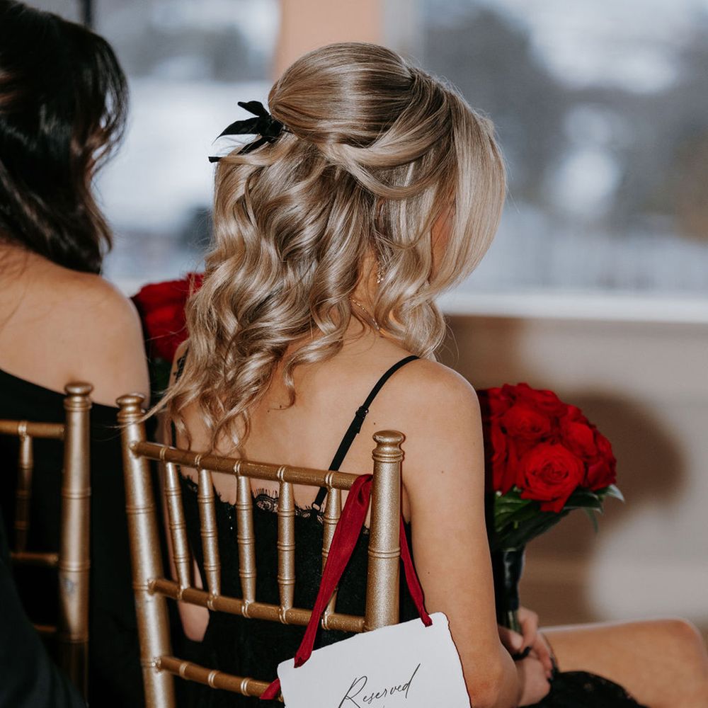 bridesmaid-wearing-black-bridesmaid-dress-with-reserved-seat-sign