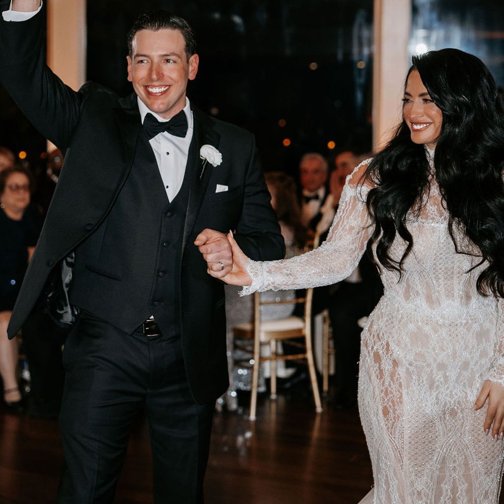 couple-exits-wedding-with-hands-in-the-air