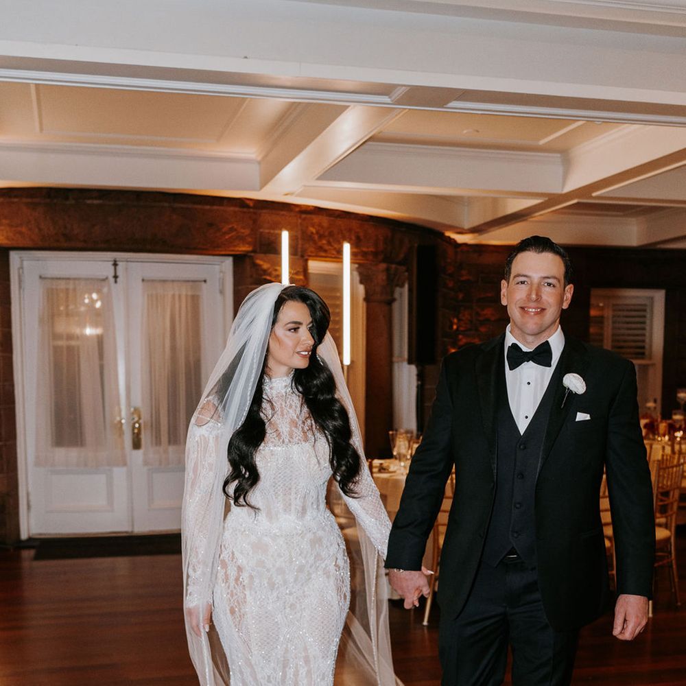 groom-in-black-tuxedo-with-bride-in-sparkly-long-sleeve-wedding-dress