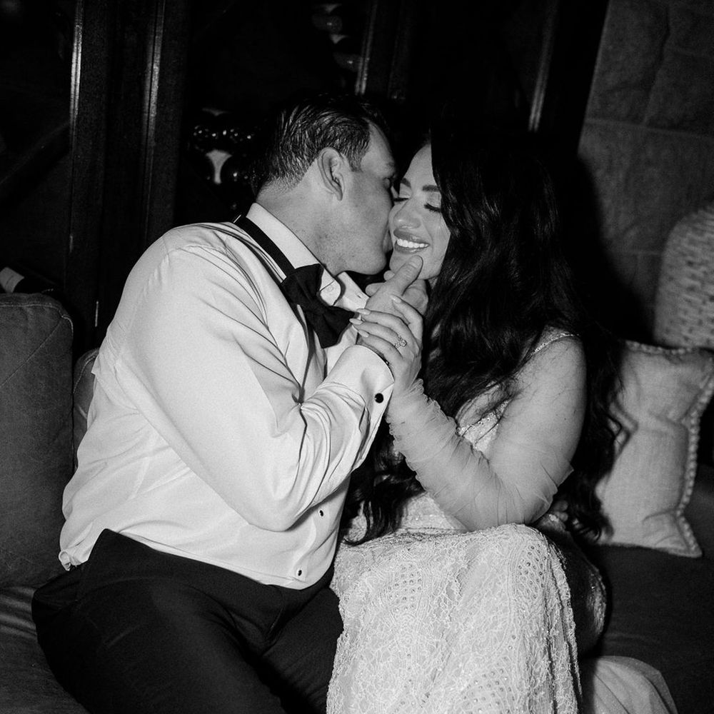 groom-kisses-bride-on-the-cheek-black-and-white-wedding-photo.