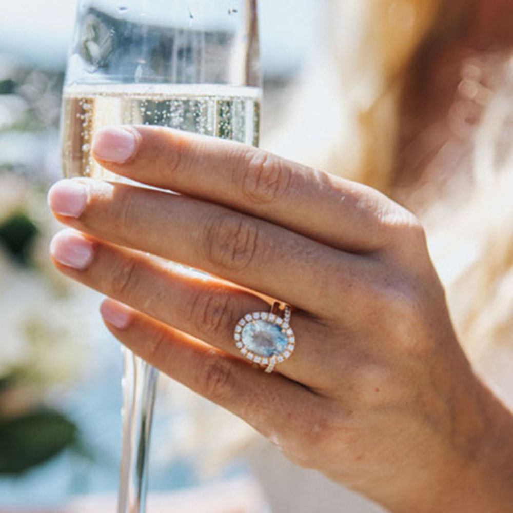 Light blue halo engagement ring