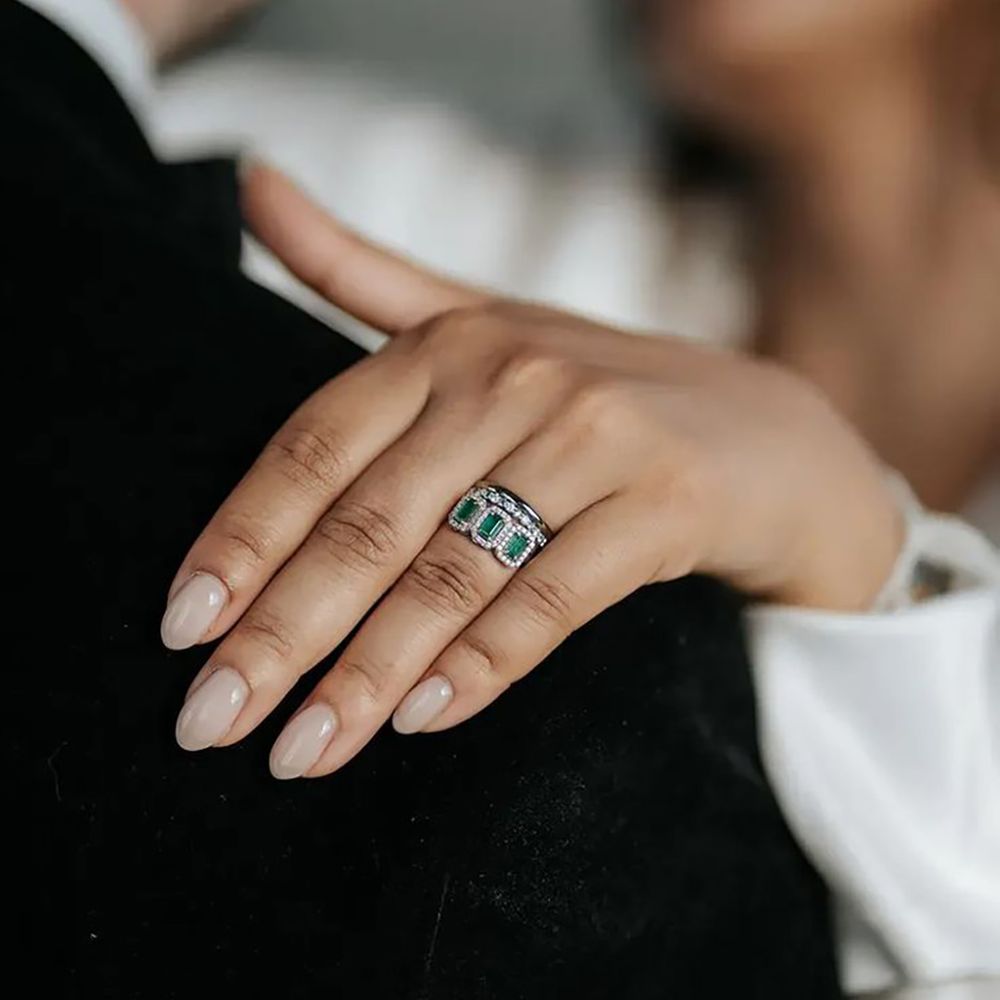 Trinity stone emerald vintage engagement ring captured during proposal shoot