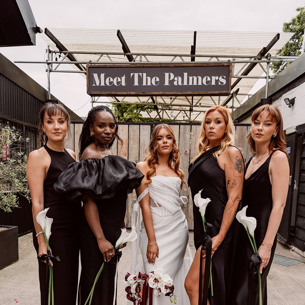 bridal-party-wearing-black-satin-bridesmaid-dresse